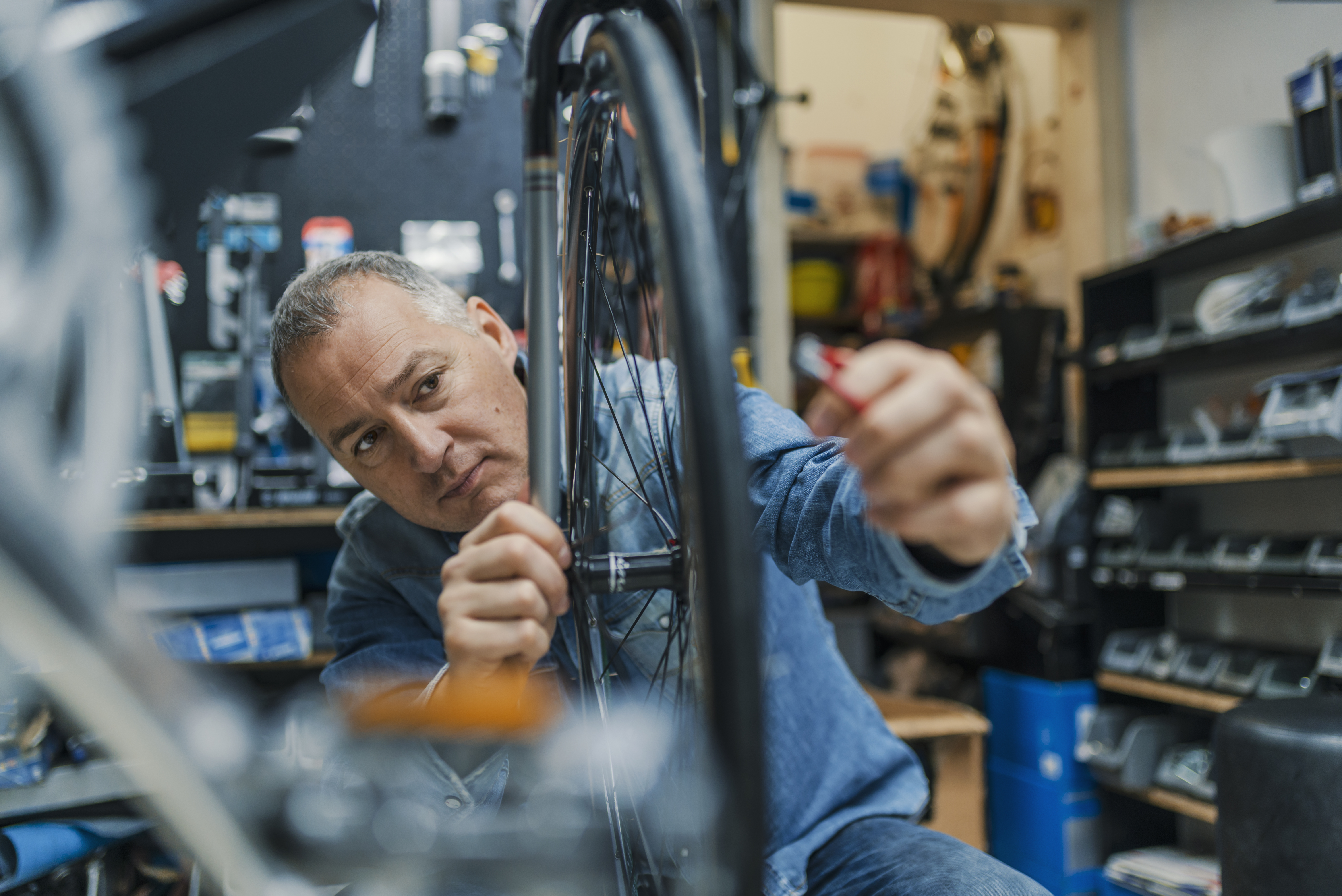 Bike shop owner repairing a bike