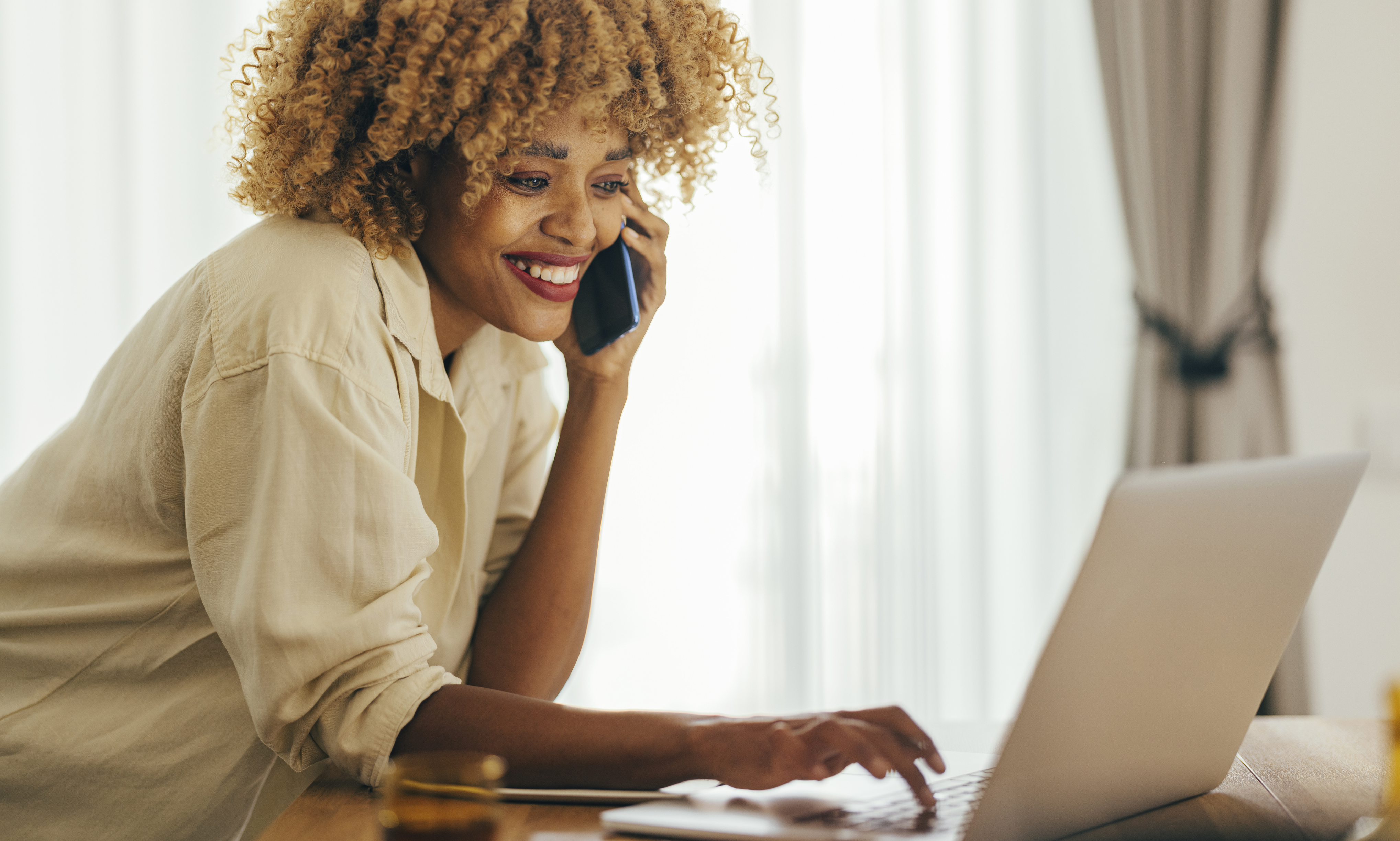 Smiling woman makes a phone call.